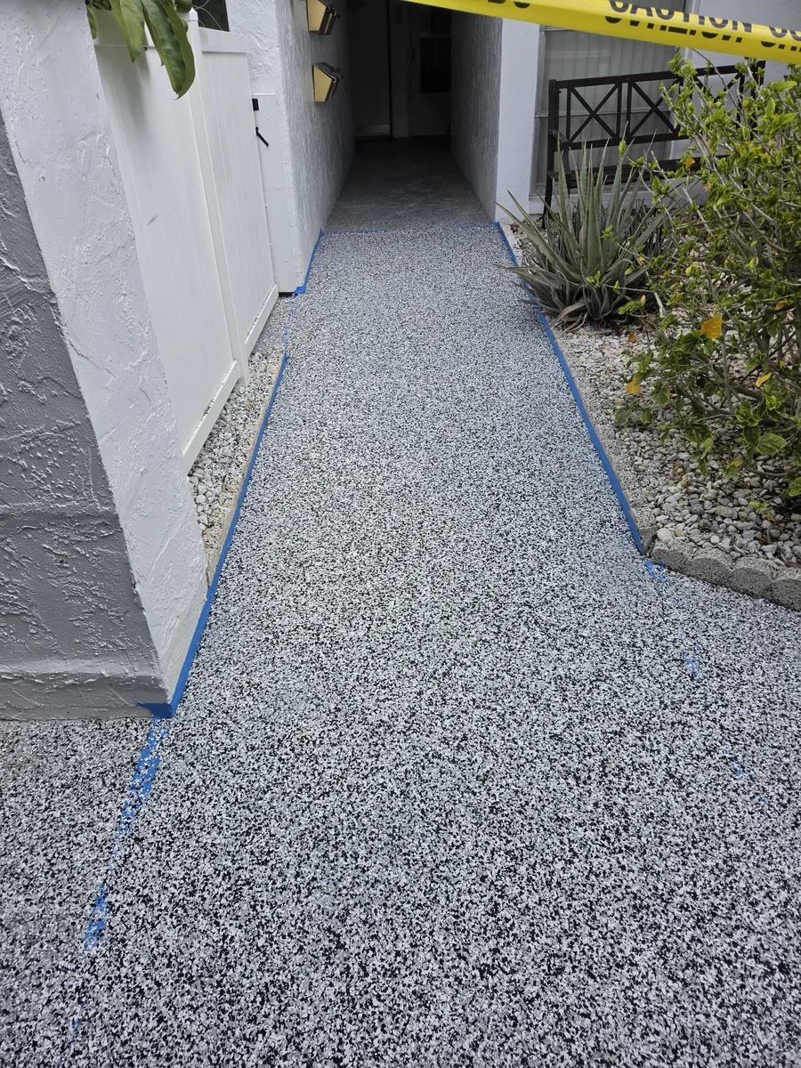 Gray flake coating system installed on a condo walkway in Pinellas County