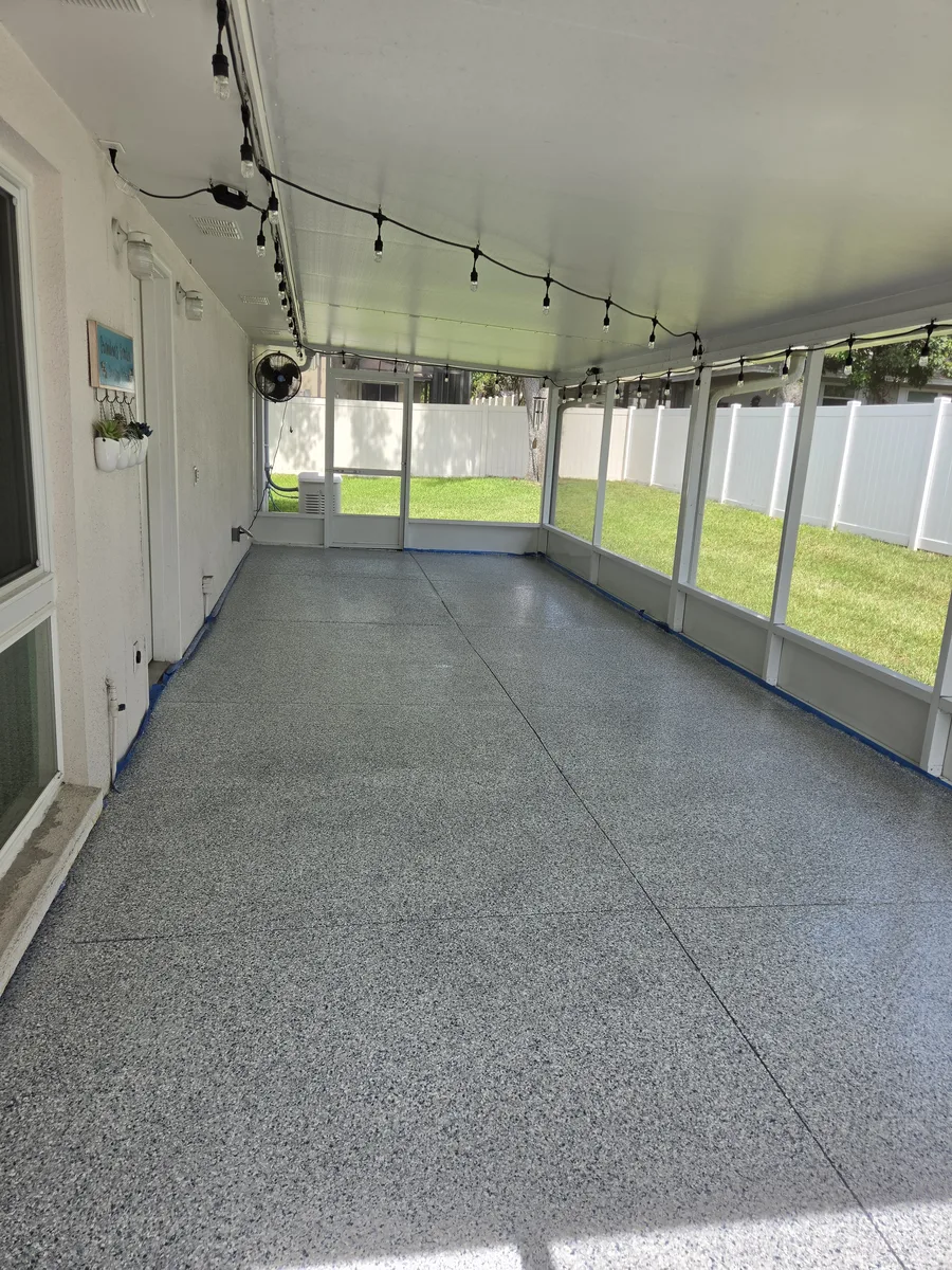 Full-broadcast flake coating on a screened lanai floor in Tampa Bay