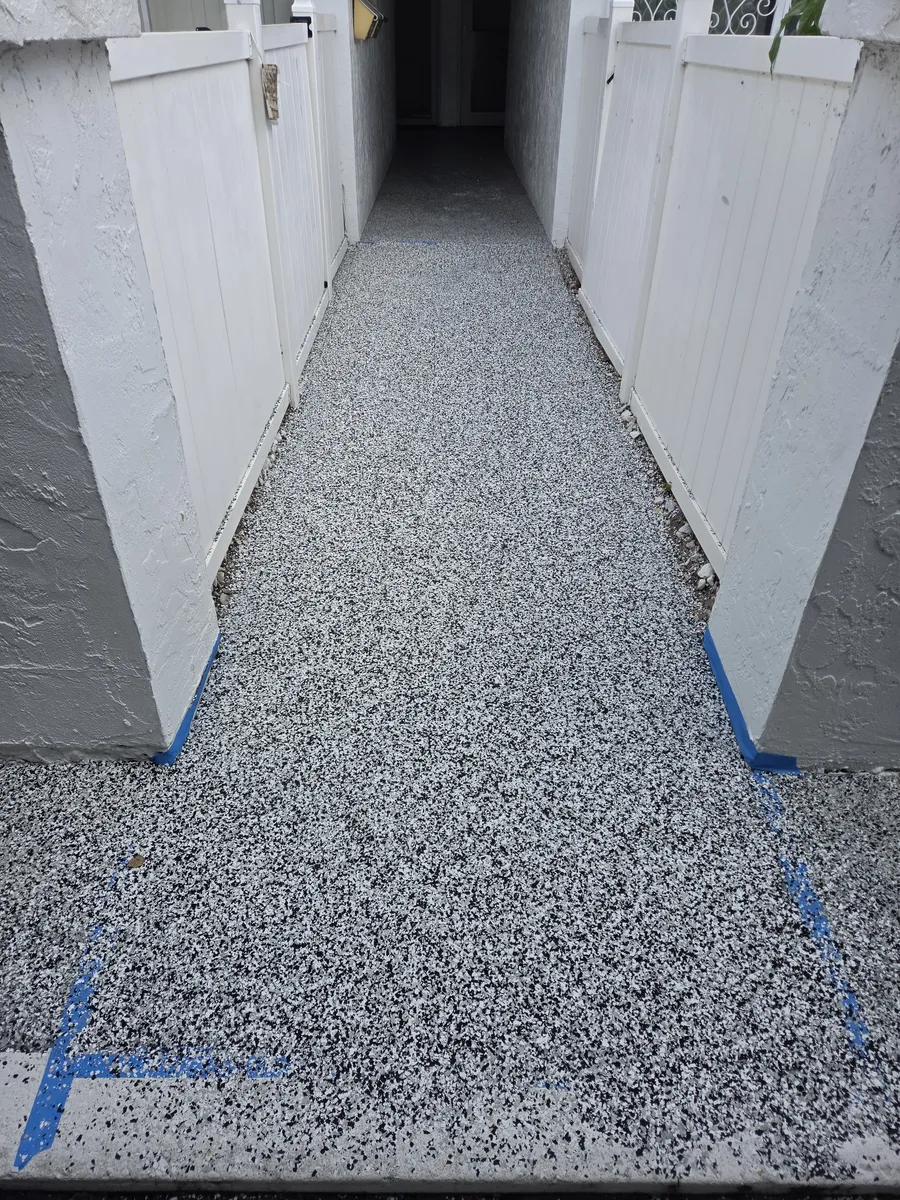 Close view of a flake coating system on an exterior concrete walkway in Pinellas County