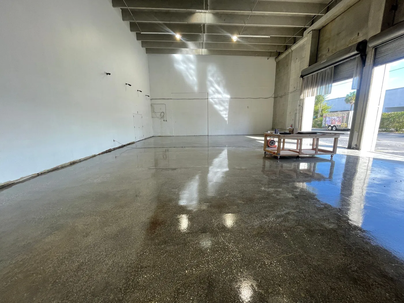 Ground and sealed concrete floor with a smooth satin finish in a commercial space