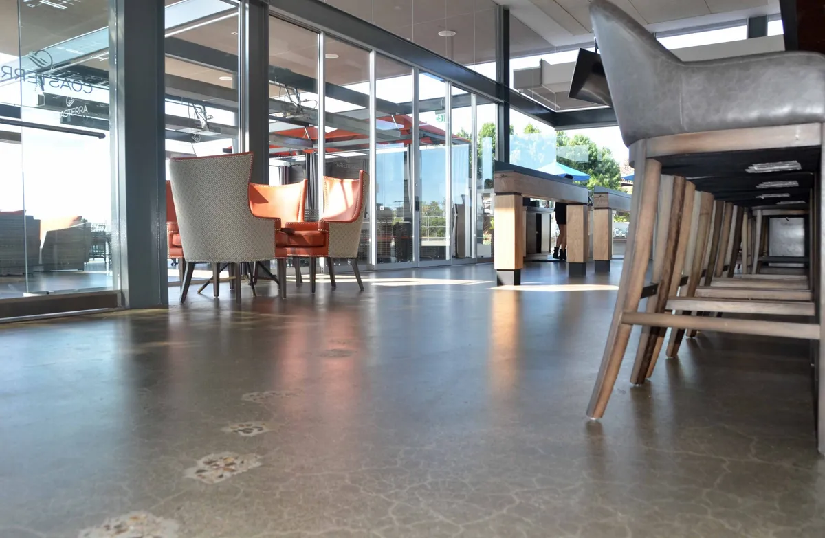 Ground and sealed concrete floor under restaurant tables and chairs